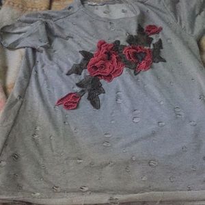A gray oversized t shirt with little rips